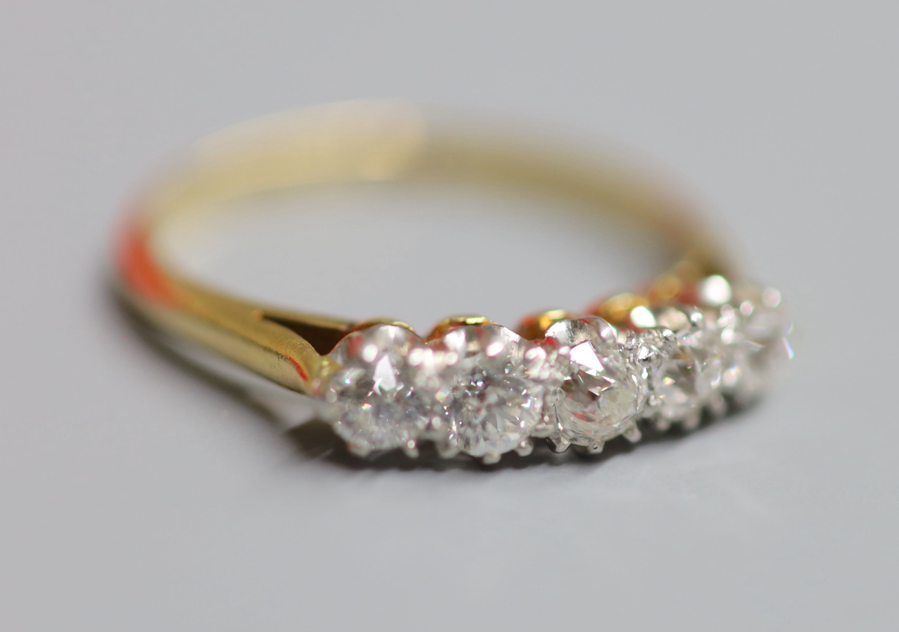 An 18ct & plat, five stone diamond set half hoop ring, size O, gross 3.2 grams.